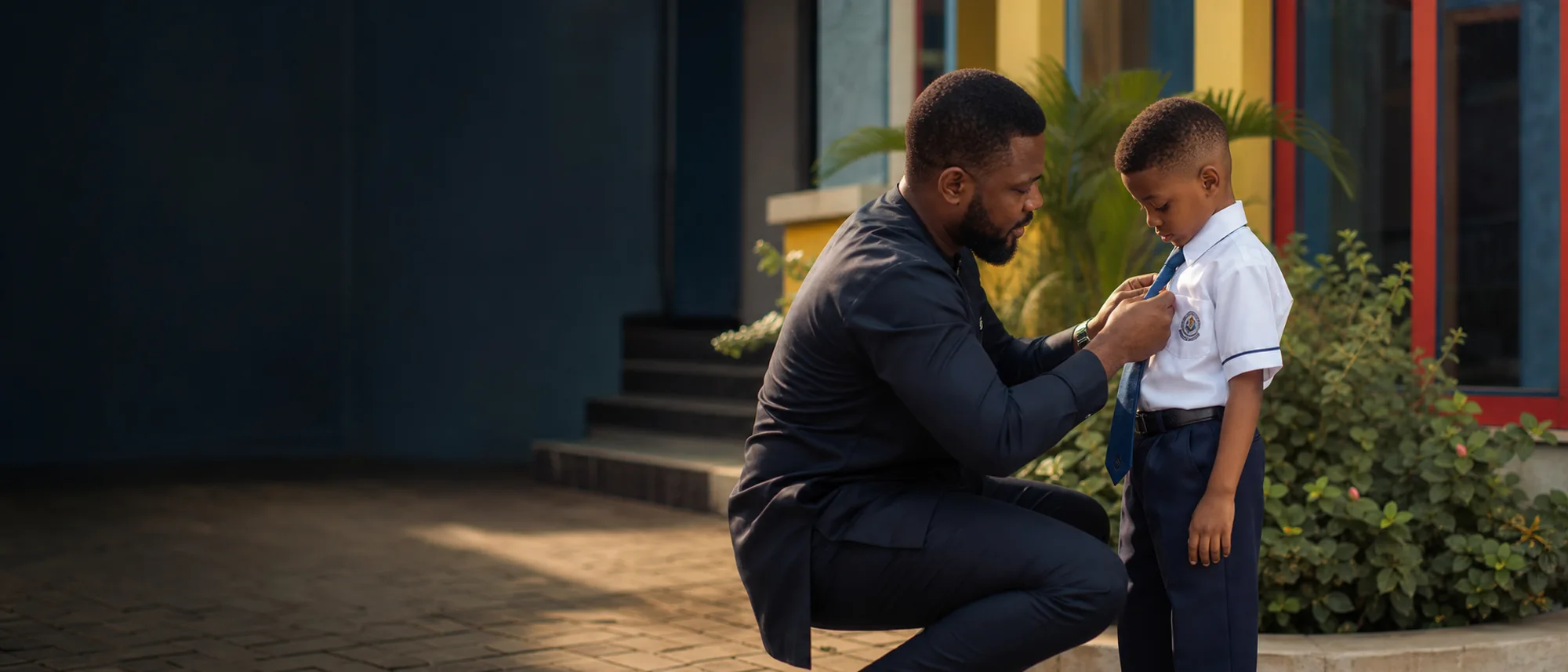 A father adjusting his son’s tie on the first day of school